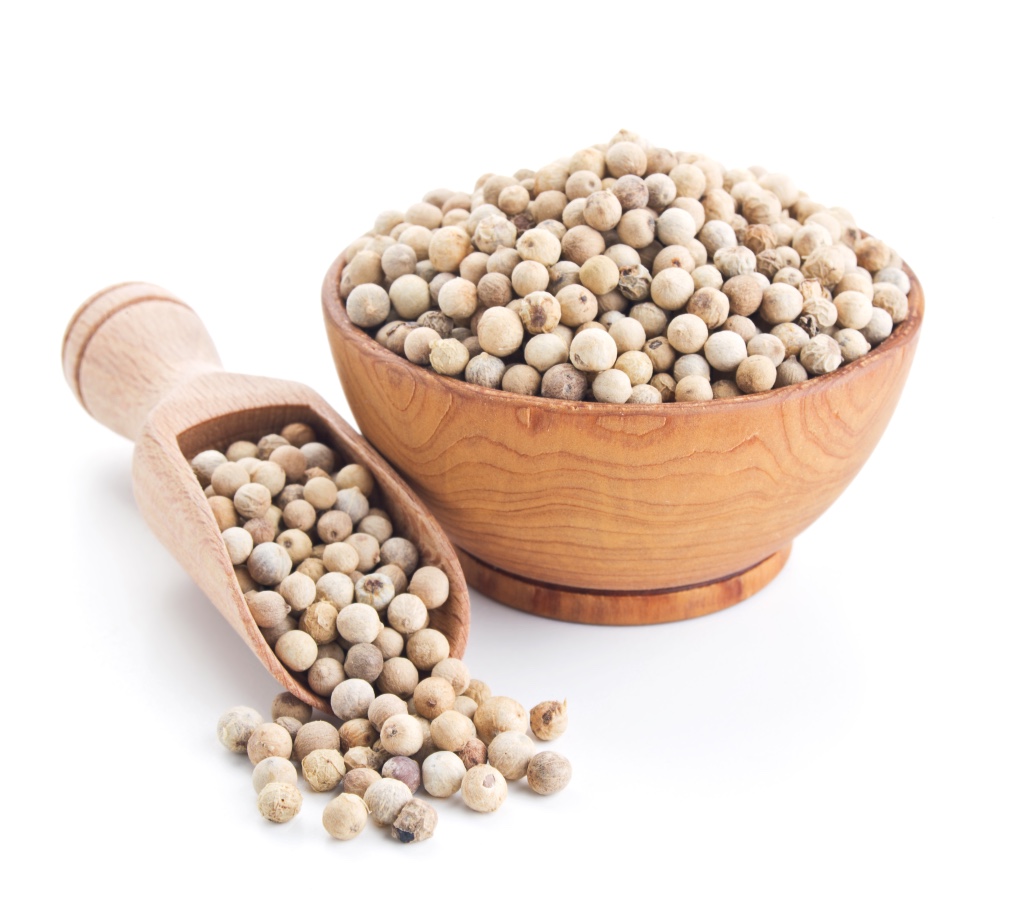 poivre blanc dans une cueiliere en bois et dans un bol